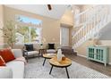 Bright living room featuring lots of natural light, neutral paint, modern furniture, and an open staircase at 2640 Overlook Dr, Broomfield, CO 80020