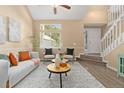 Cozy living room featuring a sofa, accent chairs, natural light, and tasteful decor at 2640 Overlook Dr, Broomfield, CO 80020