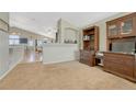 Inviting carpeted living space with a glimpse of the kitchen, dining area, and stylish wooden furniture at 12868 Capital Creek St, Parker, CO 80134