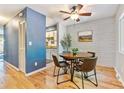 Cozy dining area with hardwood floors, a round table with chairs, and a ceiling fan at 1060 S Parker Rd # 25, Denver, CO 80231
