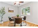 Charming dining area featuring hardwood floors, bright natural light, and a round table with chairs at 1060 S Parker Rd # 25, Denver, CO 80231