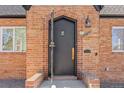 Arched brick entryway showcasing a stylish black front door with decorative ironwork at 1467 Clermont St, Denver, CO 80220