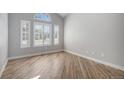 Bright room showcasing wood floors and large windows with plantation shutters at 4431 W Jamison Pl, Littleton, CO 80128