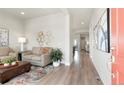 Inviting living room features modern decor, wood floors, an open layout and a flood of natural light at 21209 E 62Nd Ave, Aurora, CO 80019