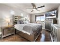 Serene main bedroom with ample natural light, hardwood floors, and stylish furnishings at 18651 E 53Rd Ave, Denver, CO 80249