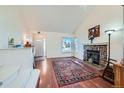 Bright living room boasts a stone fireplace, hardwood floors, and ample natural light at 4386 Sable St, Denver, CO 80239