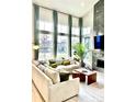Bright living room with high ceilings, large windows, and stylish decor at 6237 Stable View St, Castle Pines, CO 80108