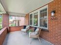 Inviting front porch featuring brick accents, stylish seating, and a glimpse of the neighborhood at 660 S Clarkson St, Denver, CO 80209