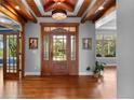 Grand entrance featuring a wood door, hardwood floors, and ample natural light, offering a warm welcome at 422 Suffolk Ln, Castle Rock, CO 80108