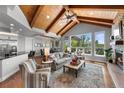 Open concept living room with vaulted ceilings, exposed beams, and expansive windows showcasing outdoor views at 422 Suffolk Ln, Castle Rock, CO 80108