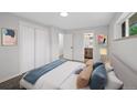 Bright bedroom with a white closet, an open door to the bathroom, and modern decor at 9025 W 4Th Ave, Lakewood, CO 80226