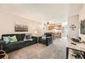 Inviting living room open to kitchen featuring a cozy sofa and neutral tones at 2208 Emery St, Longmont, CO 80501