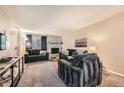 Comfortable living room features a brick fireplace, plush seating, and natural light at 2208 Emery St, Longmont, CO 80501