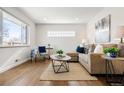 Bright living room features hardwood floors, a large window, and stylish furnishings at 7891 Maria St, Westminster, CO 80030