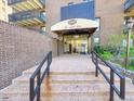 The Park Lane entrance has a covered awning, glass doors, and brick walls at 480 S Marion Pkwy # 1202, Denver, CO 80209