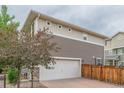Spacious two-car garage featuring a brick-paved driveway and a contemporary home exterior at 18112 E 104Th Way, Commerce City, CO 80022