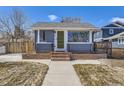 Charming single-story home featuring a well-kept lawn, classic brick accents, and a bright green front door at 4441 N Meade St, Denver, CO 80211