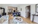 Bright living room featuring hardwood floors, a modern fireplace, and an open concept design at 4441 N Meade St, Denver, CO 80211