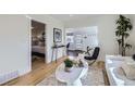 Bright living room featuring hardwood floors, white walls, and modern decor at 4441 N Meade St, Denver, CO 80211