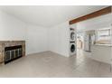 Living room with fireplace, tile floors and kitchen view at 17286 E Ford Dr, Aurora, CO 80017