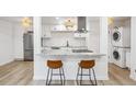 Bright kitchen featuring stainless steel appliances, granite counters, and breakfast bar at 7995 E Mississippi Ave # A4, Denver, CO 80247