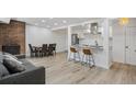 Inviting living area with brick fireplace, dining table, and breakfast bar at 7995 E Mississippi Ave # A4, Denver, CO 80247