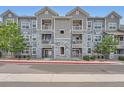 Charming apartment building with grey stone and white trim, offering a modern living space at 1831 S Dunkirk St # 103, Aurora, CO 80017