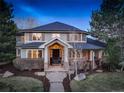 Charming home with stone accents, a welcoming front porch, and a professionally landscaped yard at 6724 S Yates Ct, Littleton, CO 80128
