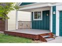 Inviting front porch offering a cozy outdoor space with metal steps at 7680 Elmwood St, Littleton, CO 80125