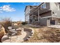 Backyard features a stone fire pit and a spacious deck with a pergola, perfect for outdoor enjoyment at 25669 E Fair Dr, Aurora, CO 80016