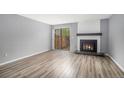 Bright living room with hardwood floors, fireplace, and sliding glass door at 4621 S Fraser Cir # B, Aurora, CO 80015