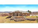 Beautiful single Gathering home with grand entryway, stone accents, and a landscaped front yard on a sunny day at 1552 Colt Cir, Castle Rock, CO 80109
