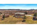 Expansive home boasts mature landscaping, stone accents and spectacular views of the surrounding area at 1552 Colt Cir, Castle Rock, CO 80109