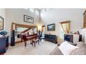 Bright living room with a grand piano, high ceilings, and ample natural light at 5448 El Diente St, Golden, CO 80403