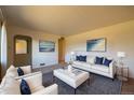 Bright living room is styled with a modern sofa, plush chairs, and contemporary decor at 971 Elm Pl, Thornton, CO 80229
