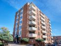 Brick building with balconies and professionally landscaped front yard under a blue sky at 850 20Th St # 503, Boulder, CO 80302