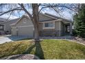 Beautiful home with well-maintained lawn and stone accents, showcasing inviting curb appeal at 271 Terra Vista St, Brighton, CO 80601