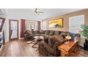 Cozy living room with a large, comfortable sectional and hardwood floors at 271 Terra Vista St, Brighton, CO 80601