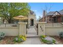Charming home featuring a gated courtyard with lush landscaping and inviting outdoor living space at 520 Jackson St, Denver, CO 80206