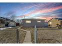 Ranch style home with a fenced yard and walkway at 5511 Leyden St, Commerce City, CO 80022