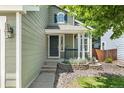 Inviting front porch with decorative stone accents, lush landscaping, and a stylish front door at 1359 S Beeler Ct, Denver, CO 80247