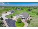 Stunning aerial view of home with three-car garage, long driveway, and lush green lawn at 2504 Elkhorn Ranch St, Parker, CO 80138