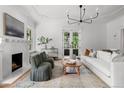 Bright living room with fireplace, large windows, and classic decor at 1500 E 7Th Ave, Denver, CO 80218
