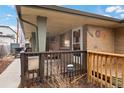 Cozy front porch with brick detail and security system, perfect for relaxing outdoors at 2461 Yates St, Denver, CO 80212