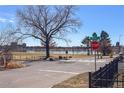 Scenic street view near calm lake features lush green spaces and a clear blue sky at 2461 Yates St, Denver, CO 80212