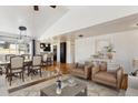 Inviting living room featuring hardwood floors, neutral tones, and stylish furnishings, adjacent to the dining area at 2651 Perry St, Denver, CO 80212