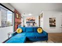 Cozy living space featuring brick accent wall, balcony access, and comfortable seating at 1898 S Bannock St # 202, Denver, CO 80223