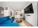 Open-concept living area features modern decor, large television, and seamless flow to the kitchen at 1898 S Bannock St # 202, Denver, CO 80223