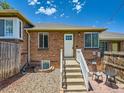 Quaint brick home with white trim, a bright white front door, and a well-maintained exterior at 4418 W 11Th Ave, Denver, CO 80204
