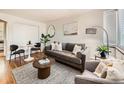 Cozy living room with a comfortable gray sofa, textured walls, and elegant decor for a relaxing atmosphere at 4418 W 11Th Ave, Denver, CO 80204